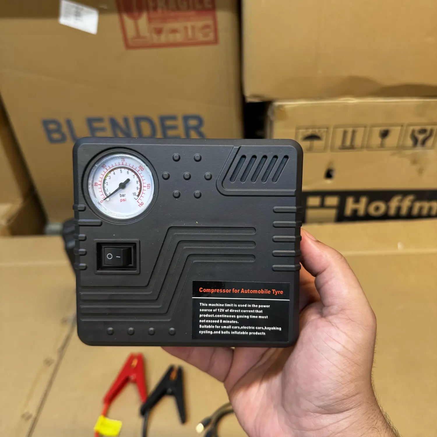 Black portable air compressor with analog pressure gauge as tire inflator for Car Jump Starter
