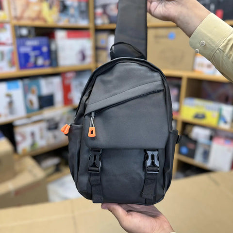Dark grey mini shoulder bag with orange zipper pulls and front buckles