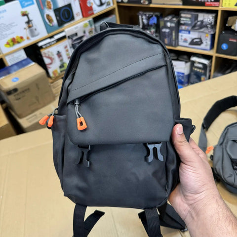 Dark gray mini shoulder bag with orange zipper pulls and front buckle closures