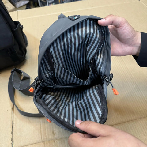 Open gray mini shoulder bag with striped interior lining and multiple pockets