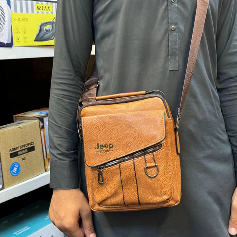 Imported leather messenger bag with tan leather, front flap, and zipper pockets