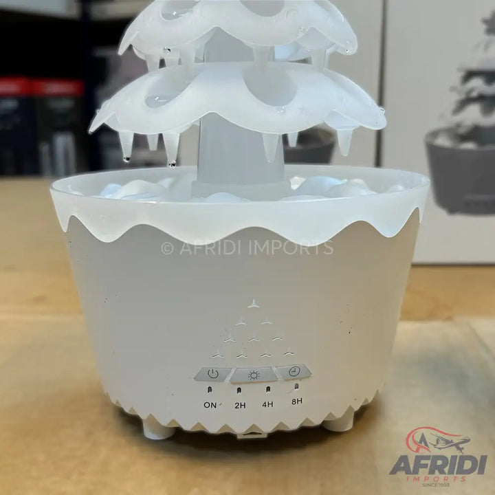 A white, multi-tiered water fountain with time-setting controls.