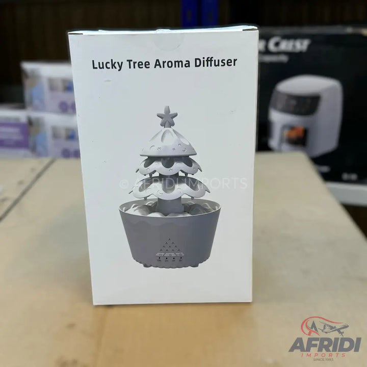 A white box containing a gray Christmas tree-shaped aroma diffuser.