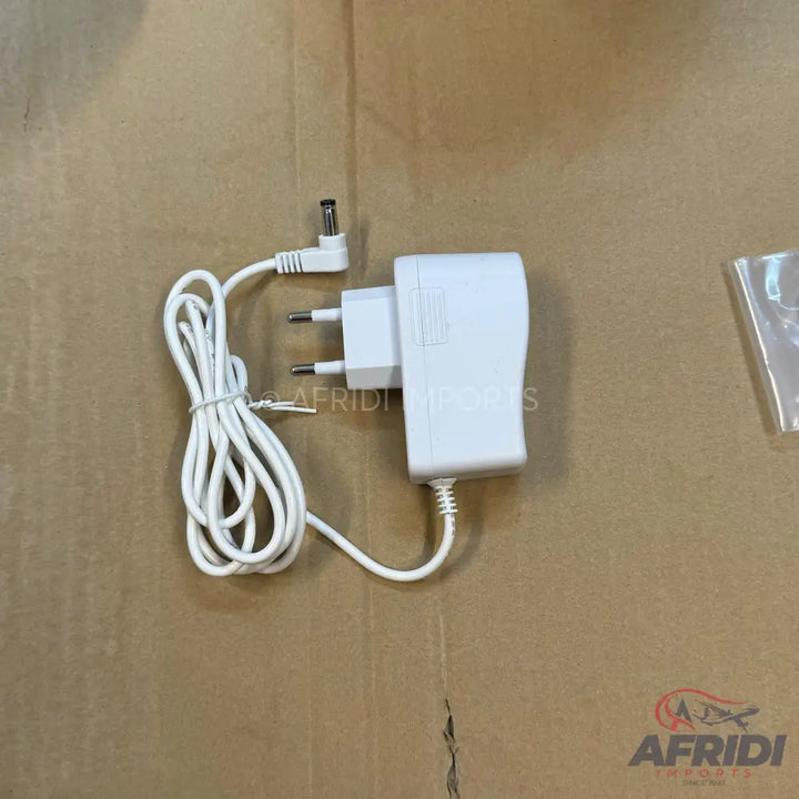 White AC power adapter with a coiled cord and DC barrel connector.