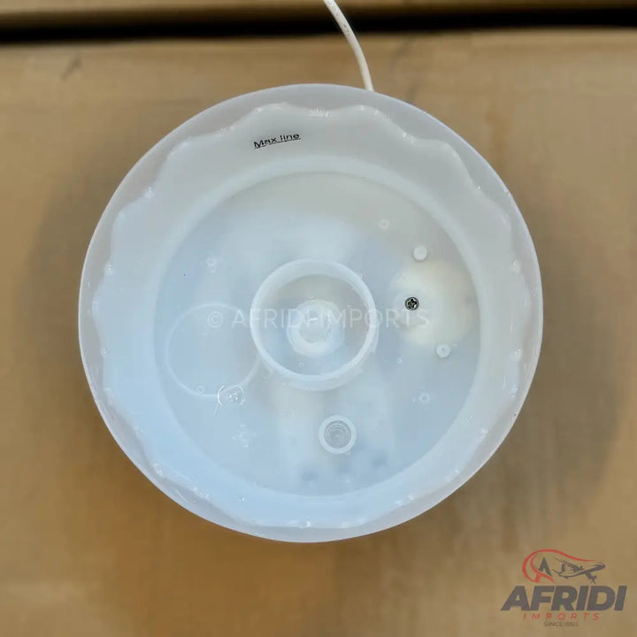 A clear, plastic, round humidifier or diffuser top with an internal max fill line.