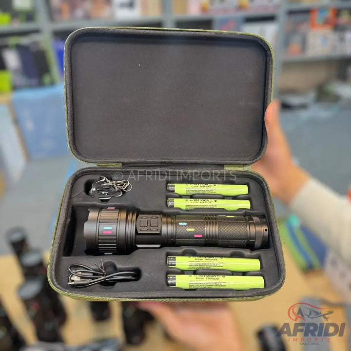 Black flashlight kit with four rechargeable batteries and a charging cable in a protective case.