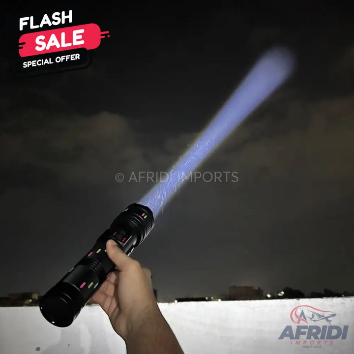 A black flashlight with a glowing blue, plasma-like beam extending from its end.
