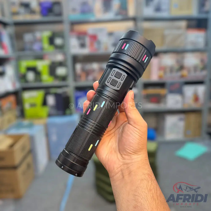 Black tactical flashlight with colorful indicator lights and a textured grip.