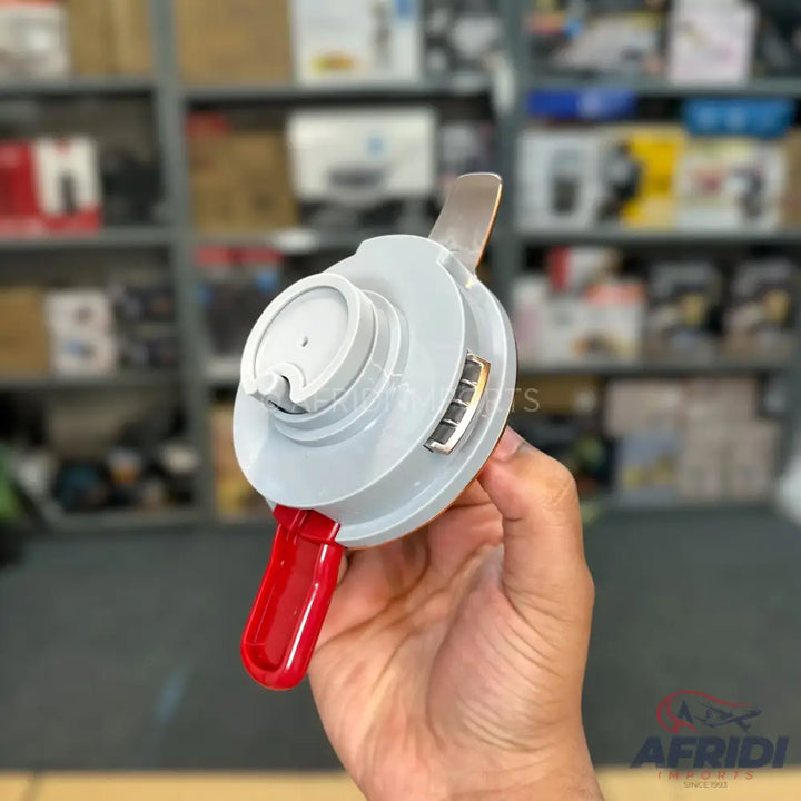 A hand-held, light gray manual food chopper with a red handle and a visible blade, designed for mincing or dicing ingredients.