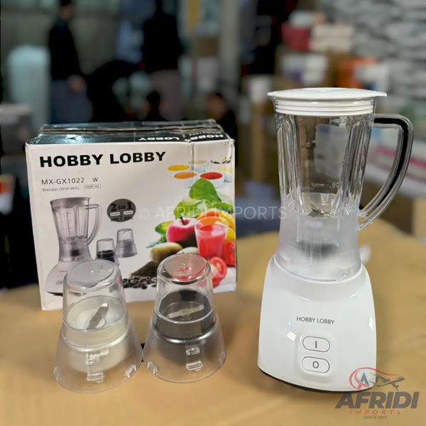 White blender with two attachments, including a grinding cup.