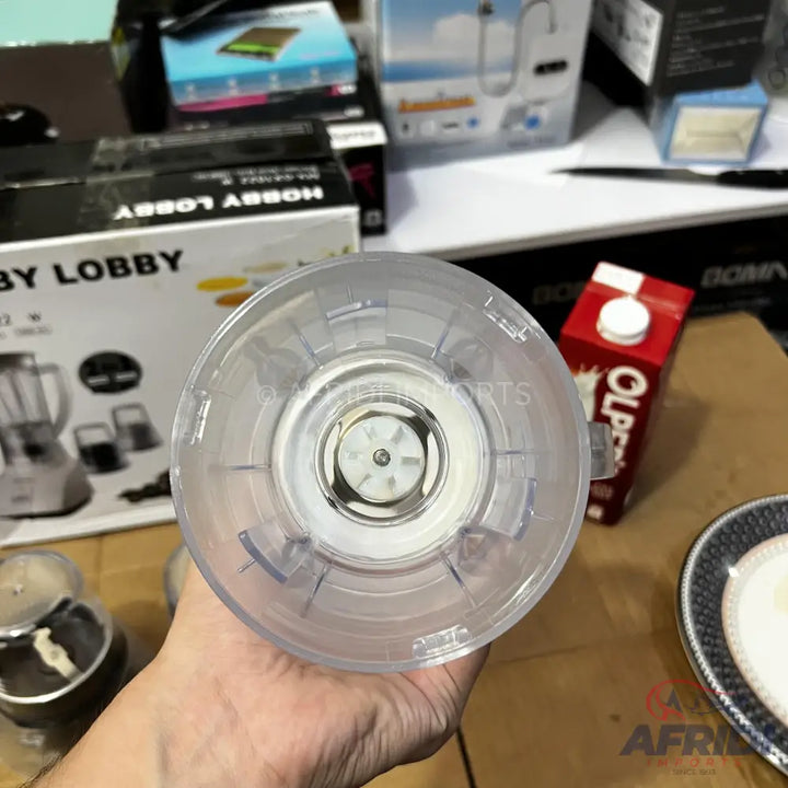 Clear plastic blender cup with a six-blade assembly.