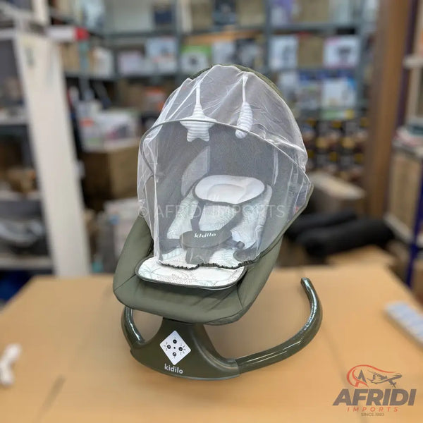 An olive-green baby bouncer with a white padded seat, safety harness, and a sheer mesh canopy with hanging star and cloud toys.