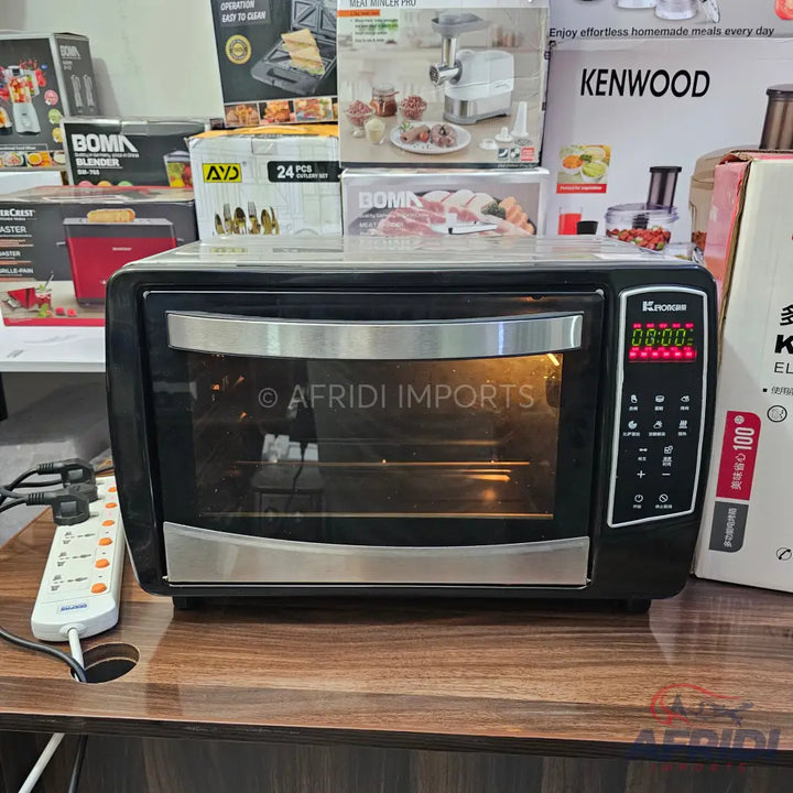 A black and silver countertop toaster oven with a digital display.
