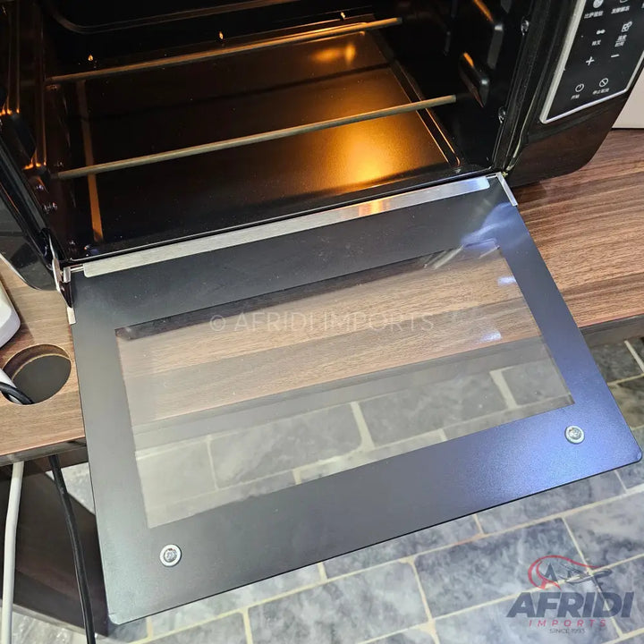 Black electric oven with an open glass door and a rotisserie rod inside.