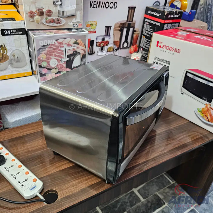 Stainless steel electric oven with a black handle.