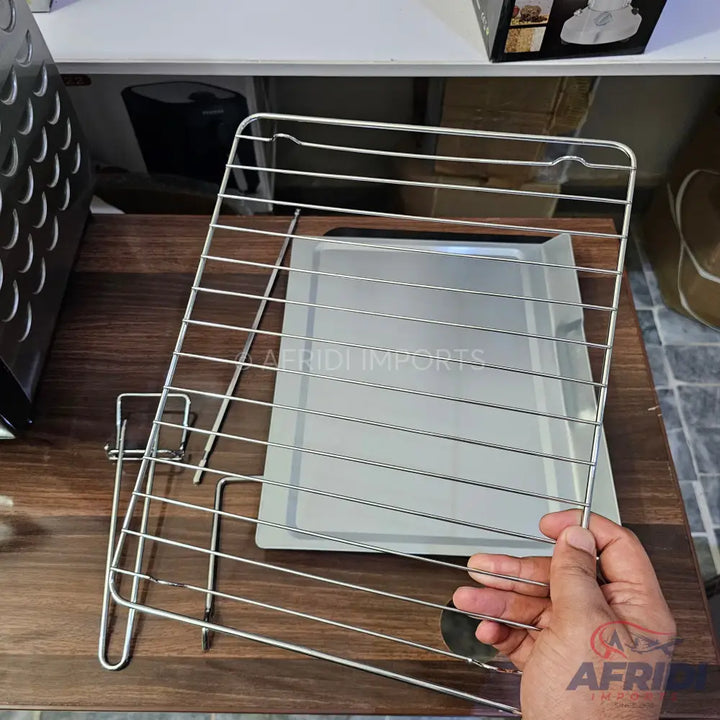 A stainless steel oven rack and baking tray set.