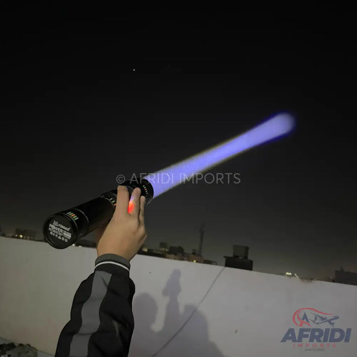 A black flashlight emitting a blue beam of light.