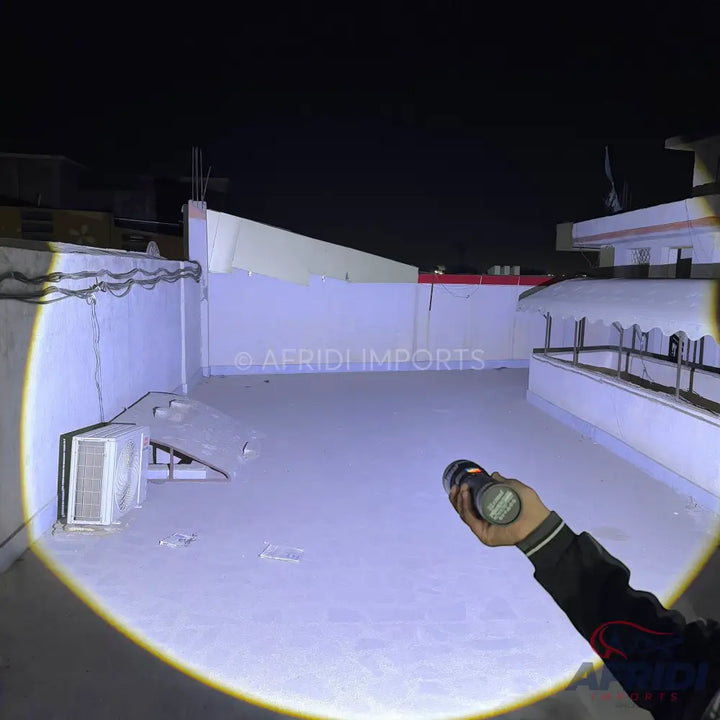 A powerful flashlight illuminating a wide area in the dark.