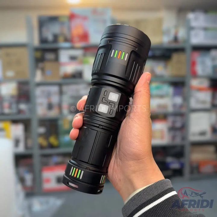 A black, handheld flashlight with multiple indicator lights and control buttons.