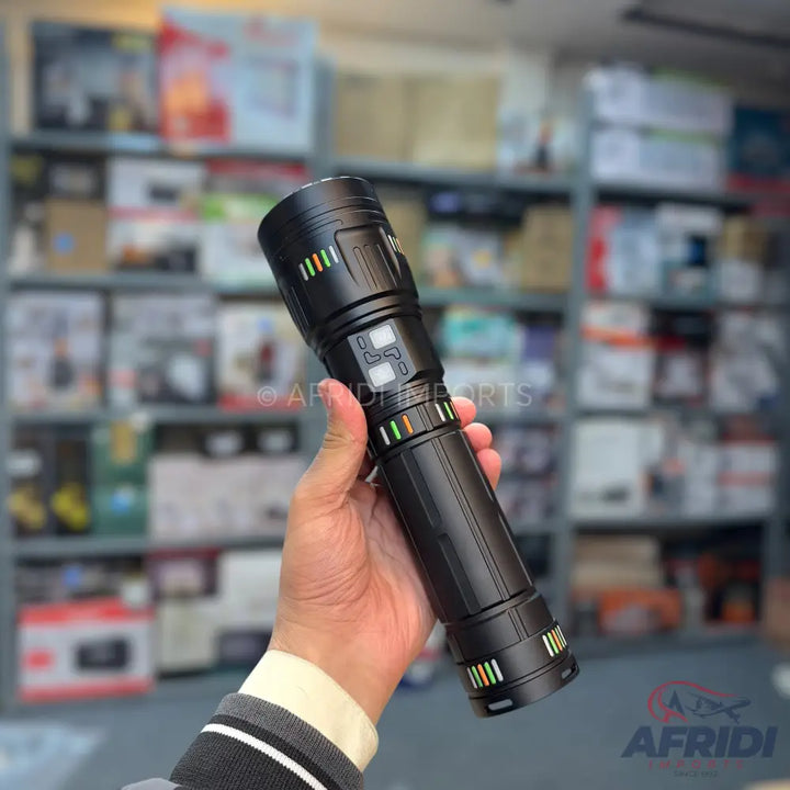 Black flashlight with colorful indicator lights and textured grip.
