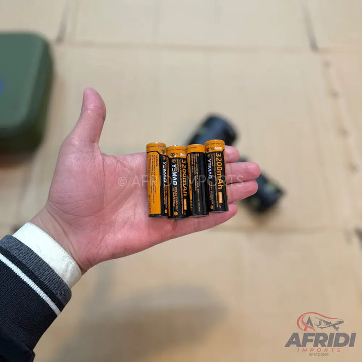 Four cylindrical batteries with yellow and black wrappers.