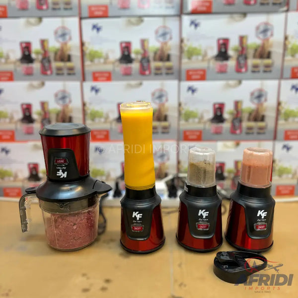 A set of red and black kitchen blenders and choppers with various attachments, including one with a tall cup containing orange juice, one with a smaller cup containing a light brown mixture, one with a small cup containing a pink mixture, and a food chopper with a clear bowl containing ground meat.