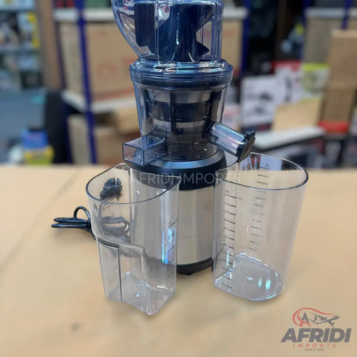 A slow masticating juicer with two clear collection cups, designed for extracting juice from fruits and vegetables.