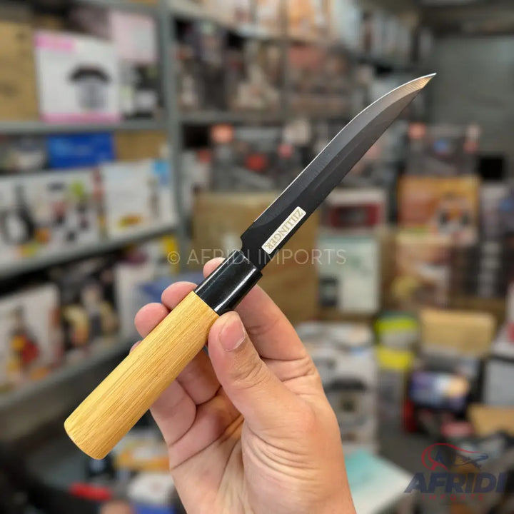 A black-bladed knife with a light wooden handle.