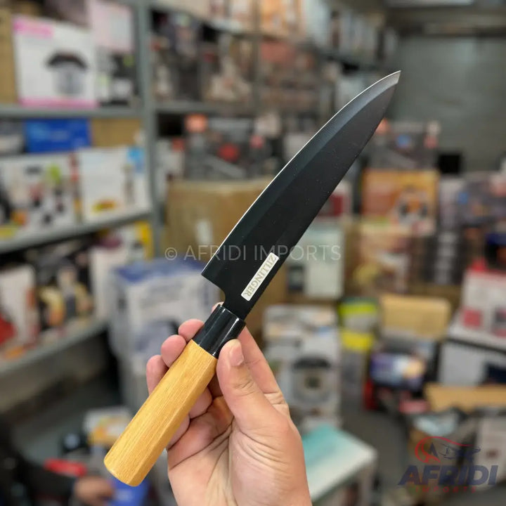 Black-bladed Japanese-style knife with a light wooden handle.