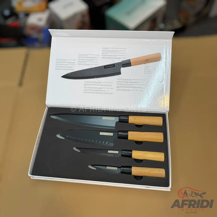 A boxed set of four black-bladed kitchen knives with light wooden handles.