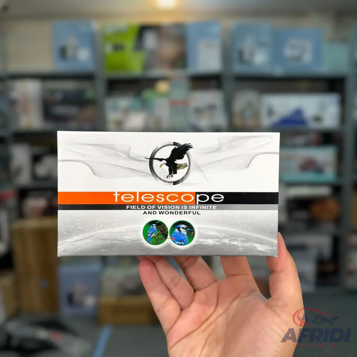 A white box with orange and black accents, featuring an eagle logo and two circular images of birds, likely for a product named ’Telescope’.