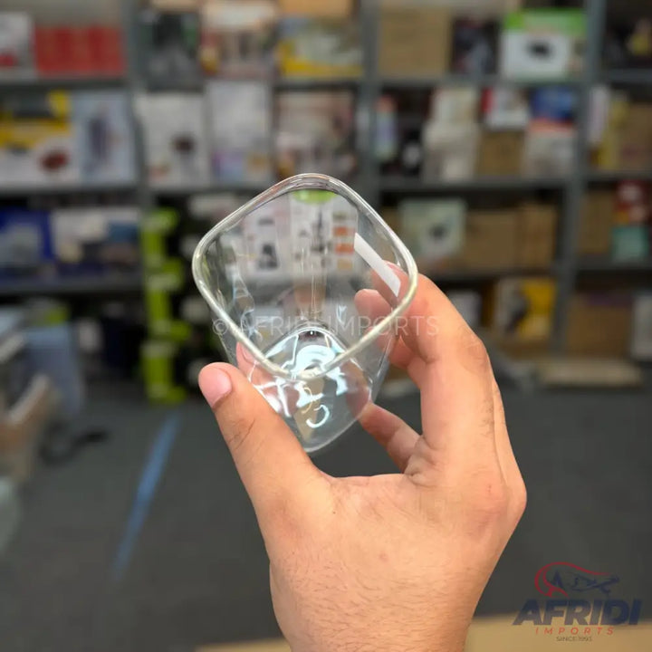 A clear, square-shaped glass with rounded corners.