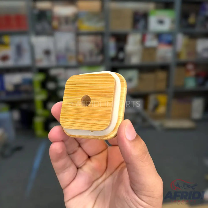 A square bamboo lid with a circular opening and a white silicone seal.