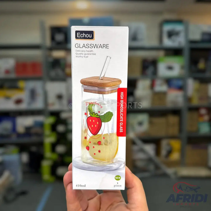 A transparent glass bottle with a wooden lid, a straw, and a strawberry design.