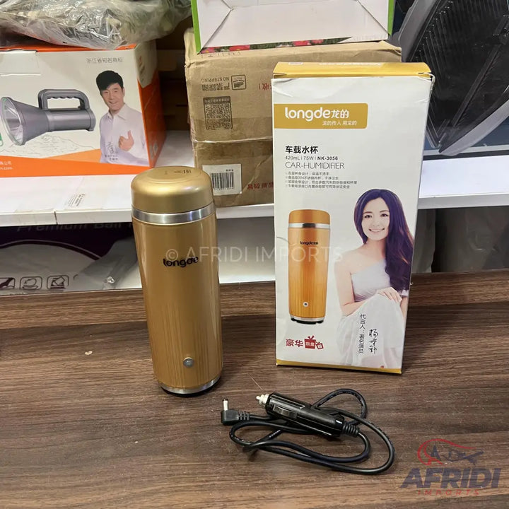 Gold cylindrical car humidifier with a car power adapter.