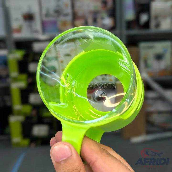 A bright green manual egg separator with a clear outer shell.