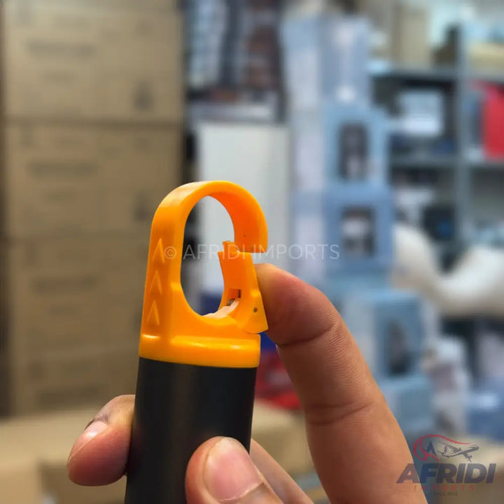 Black and yellow plastic hook with a hinged opening.