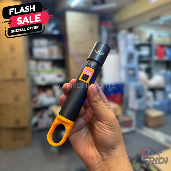 Black and orange handheld flashlight with a digital display.