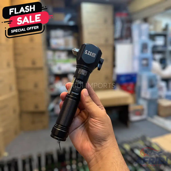 Black tactical multi-tool flashlight with a textured grip and pointed end.