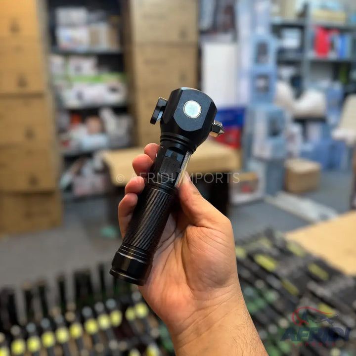 Black multi-functional flashlight with a textured grip and a white button on the head.