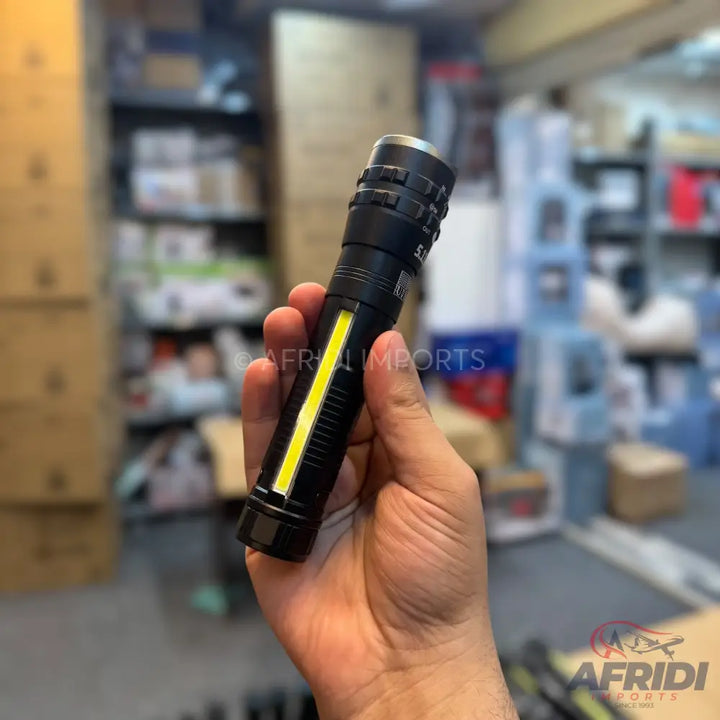 Black multi-functional flashlight with a side COB light.