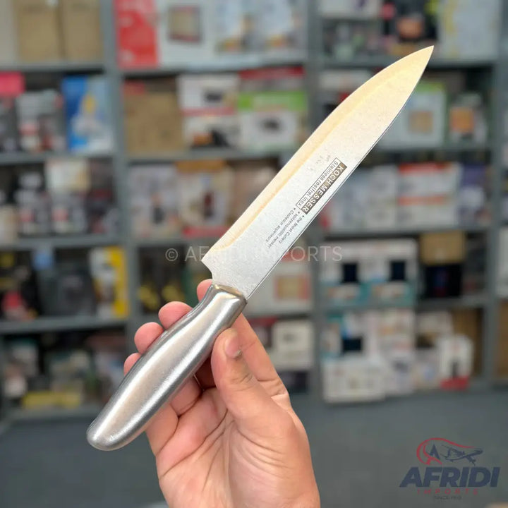 A stainless steel chef’s knife with a polished, ergonomic handle.