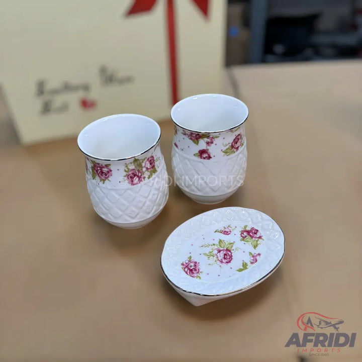 White ceramic soap dispenser with a floral pattern and diamond-textured base.