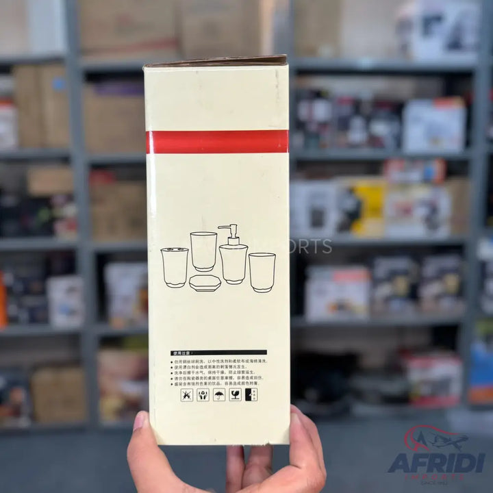 Cream-colored box with an illustration of a five-piece bathroom set (two tumblers, a soap dispenser, a toothbrush holder, and a soap dish) and Chinese text.
