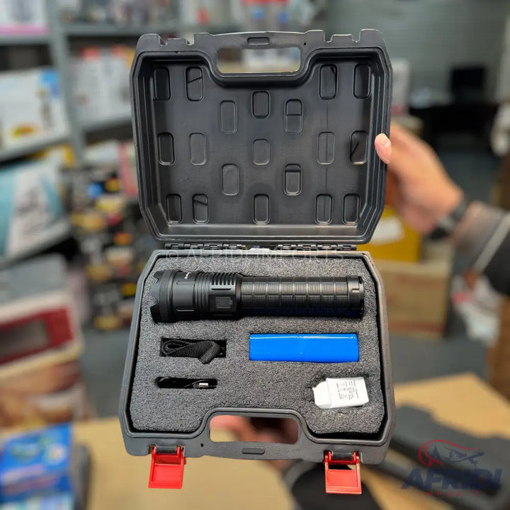 A tactical flashlight kit in a protective case, including a rechargeable battery, charging cable, and a desiccant packet.