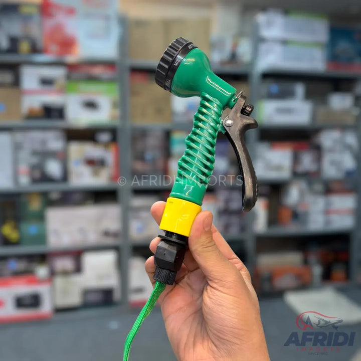 Green and yellow high-pressure spray nozzle with a black trigger.