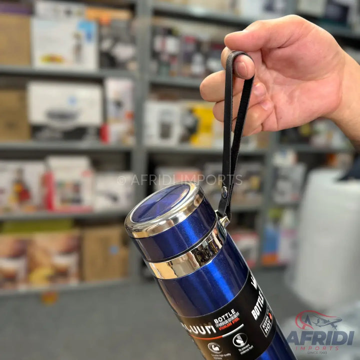 Hand-held blue and silver double-walled vacuum flask with a carrying strap.