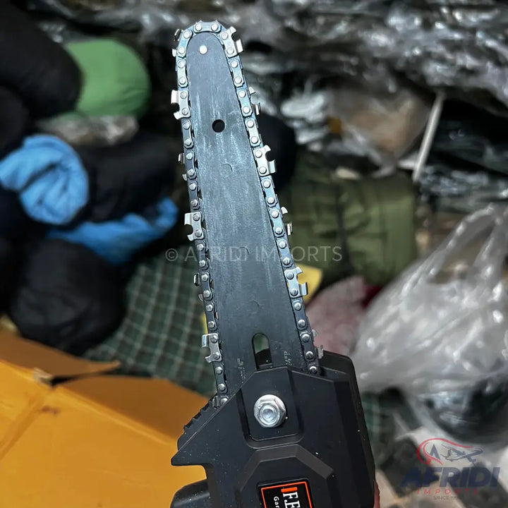 Compact black electric chainsaw with a sharp, silver chain.