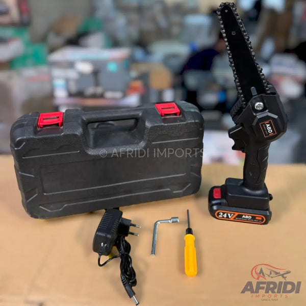 Cordless mini chainsaw with a battery, charger, toolbox, and tools.