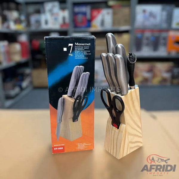 A 7-piece knife set with a wooden block, including a pair of scissors and a sharpener.